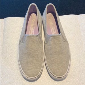 Light grey sneakers.